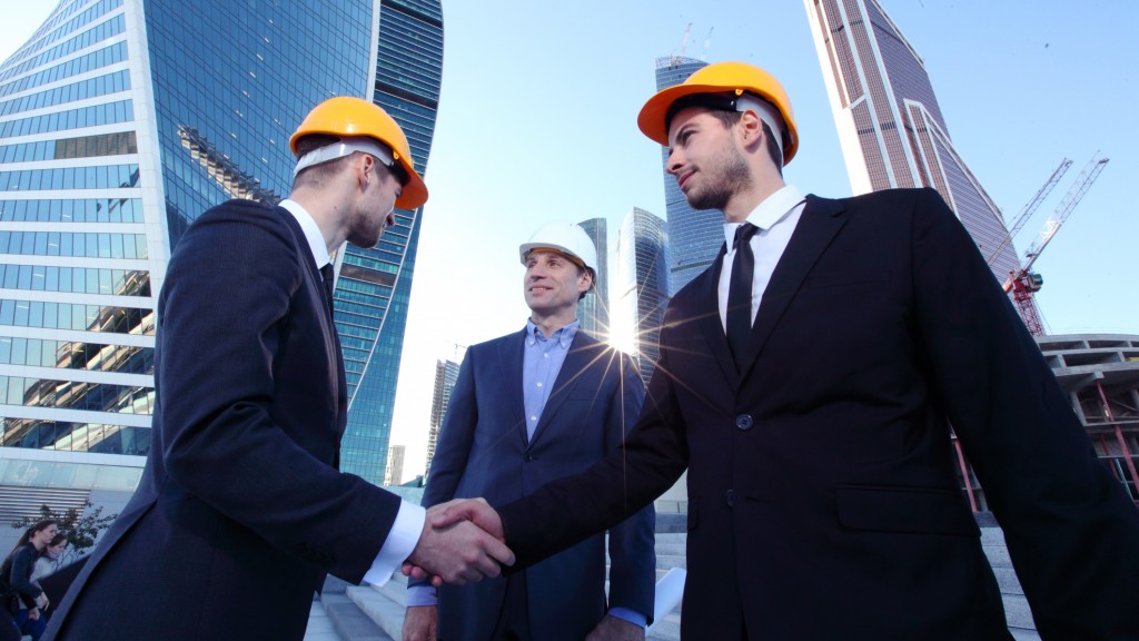 Investor and contractor shaking hands, view from below