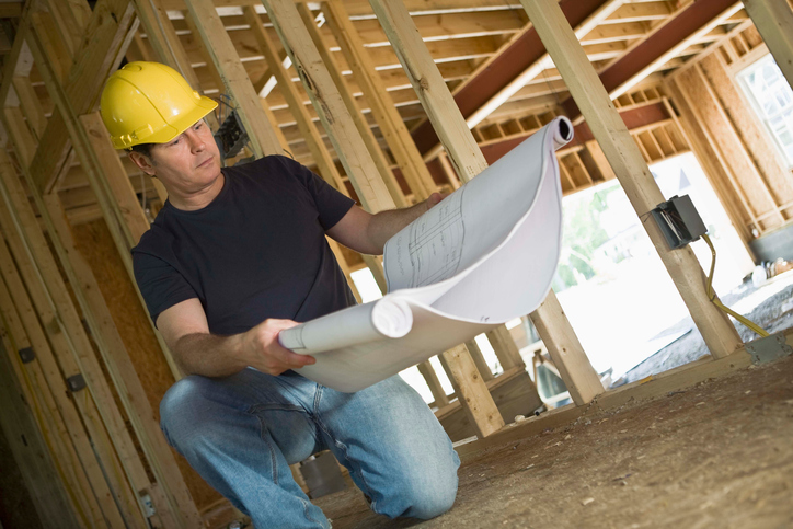 Construction worker with blueprints