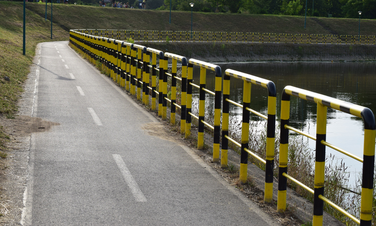 fenced bike trail by the lake