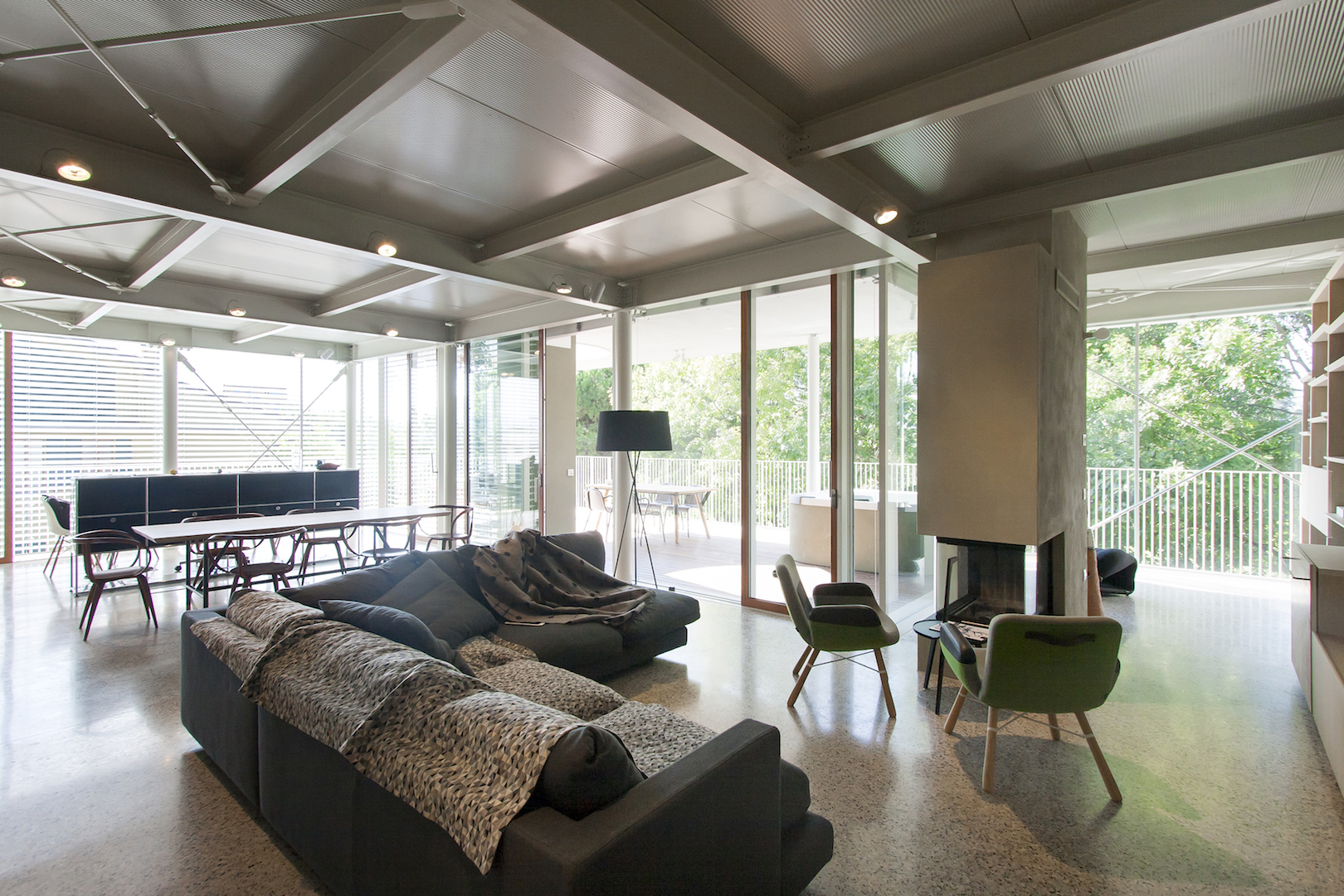Gli interni del nuovo piano abitato presentano travi in acciaio a vista e grandi superfici vetrate che aumentano il senso di leggerezza dell’intervento © Lelli & Associati Architettura