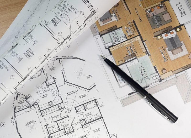 Top view of architectural blueprints and blueprint rolls