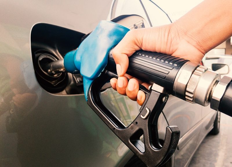 Hand holding gasoline nozzle