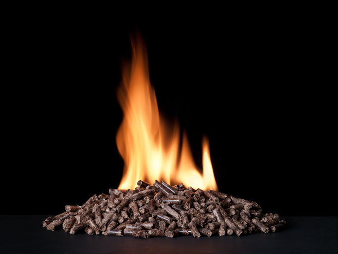 Large pile of wood pellets burning