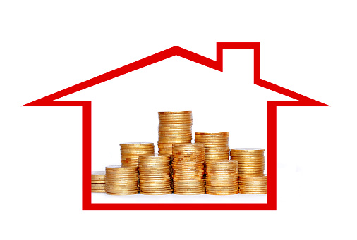 Many coins in column in house isolated on white background