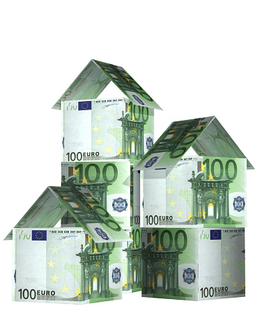 Three houses from euro banknotes. Isolated on white background